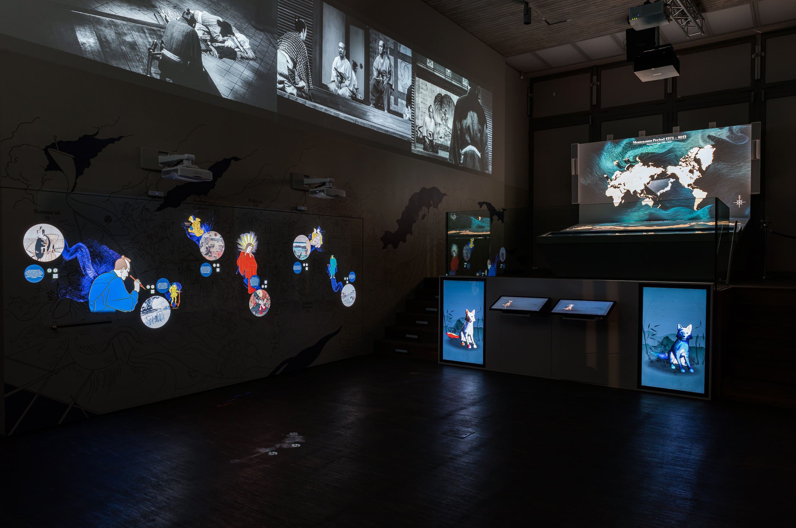 View of the first room of the museum with interactive wall, Japan table and fox painting station.