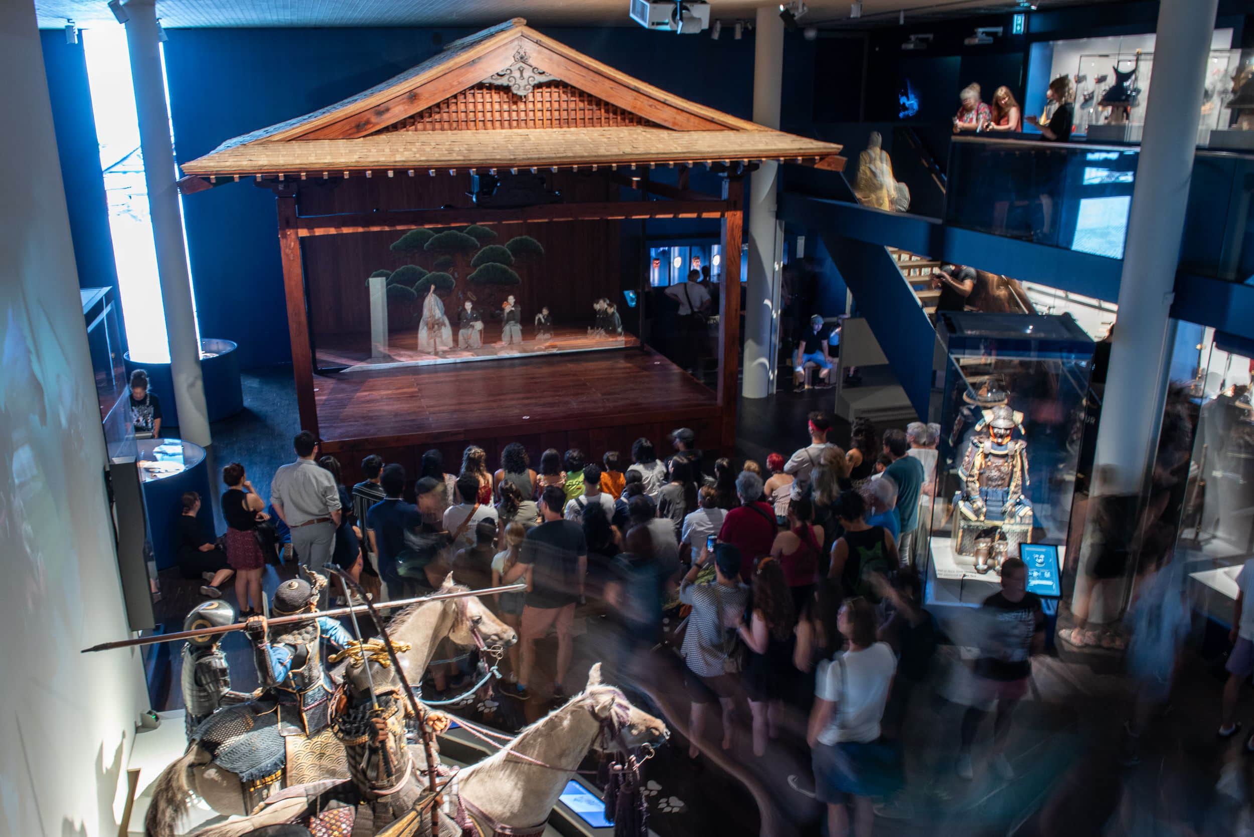 The exhibition hall with the Noh stage featuring a theatre projection.